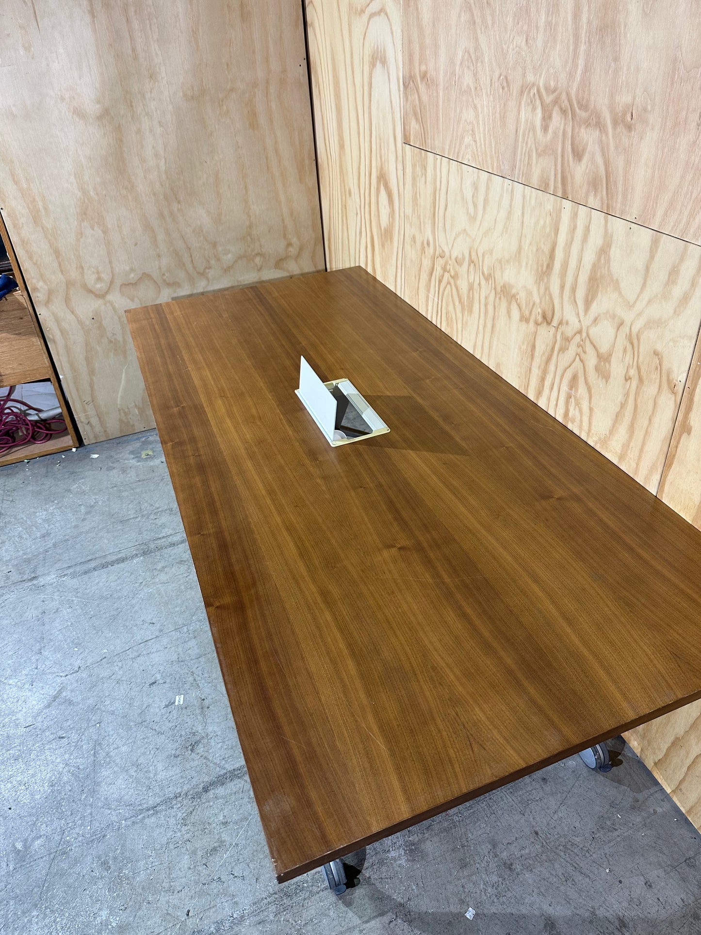 Brown flip table with power box on castors