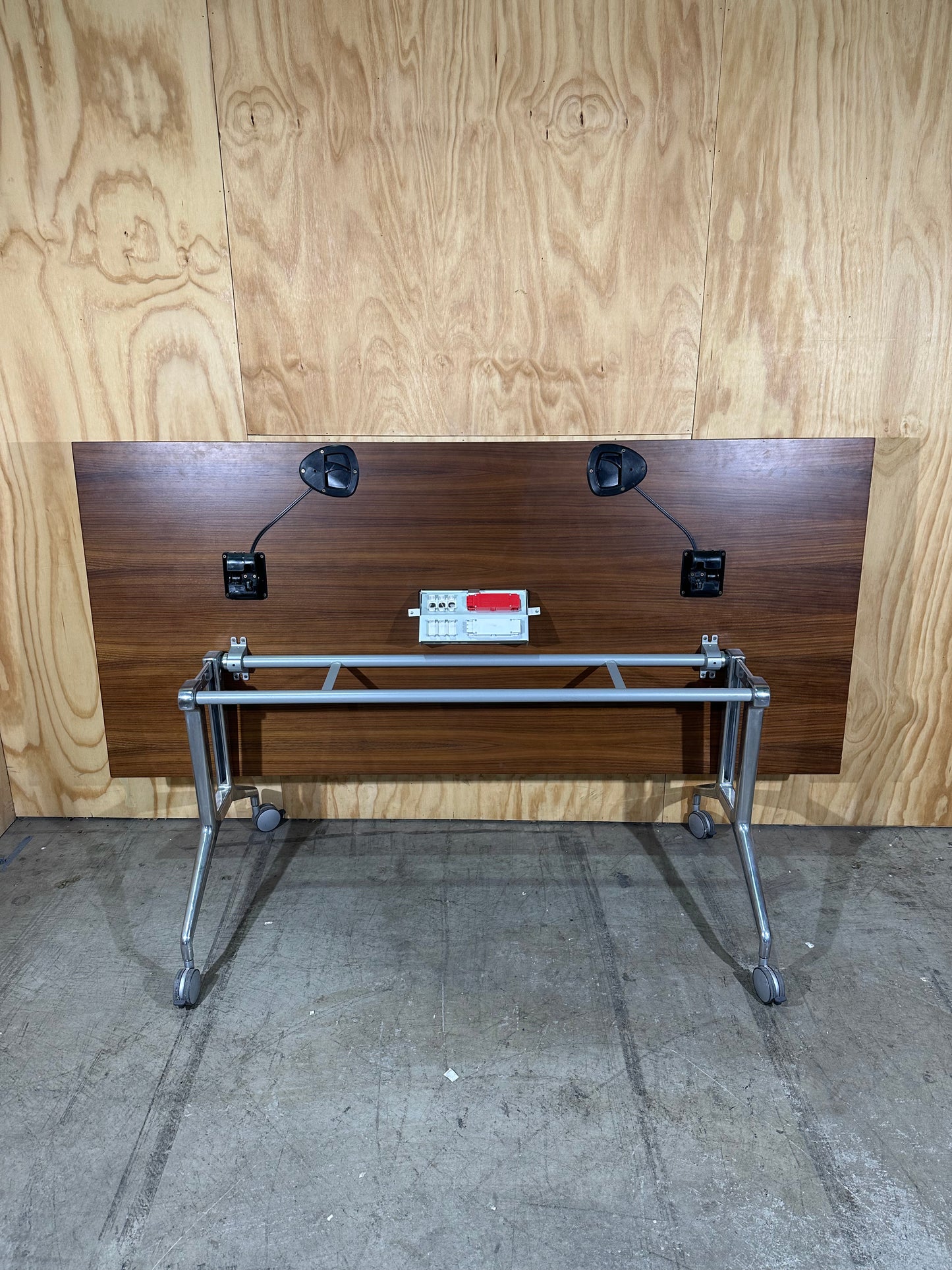 Brown flip table with power box on castors