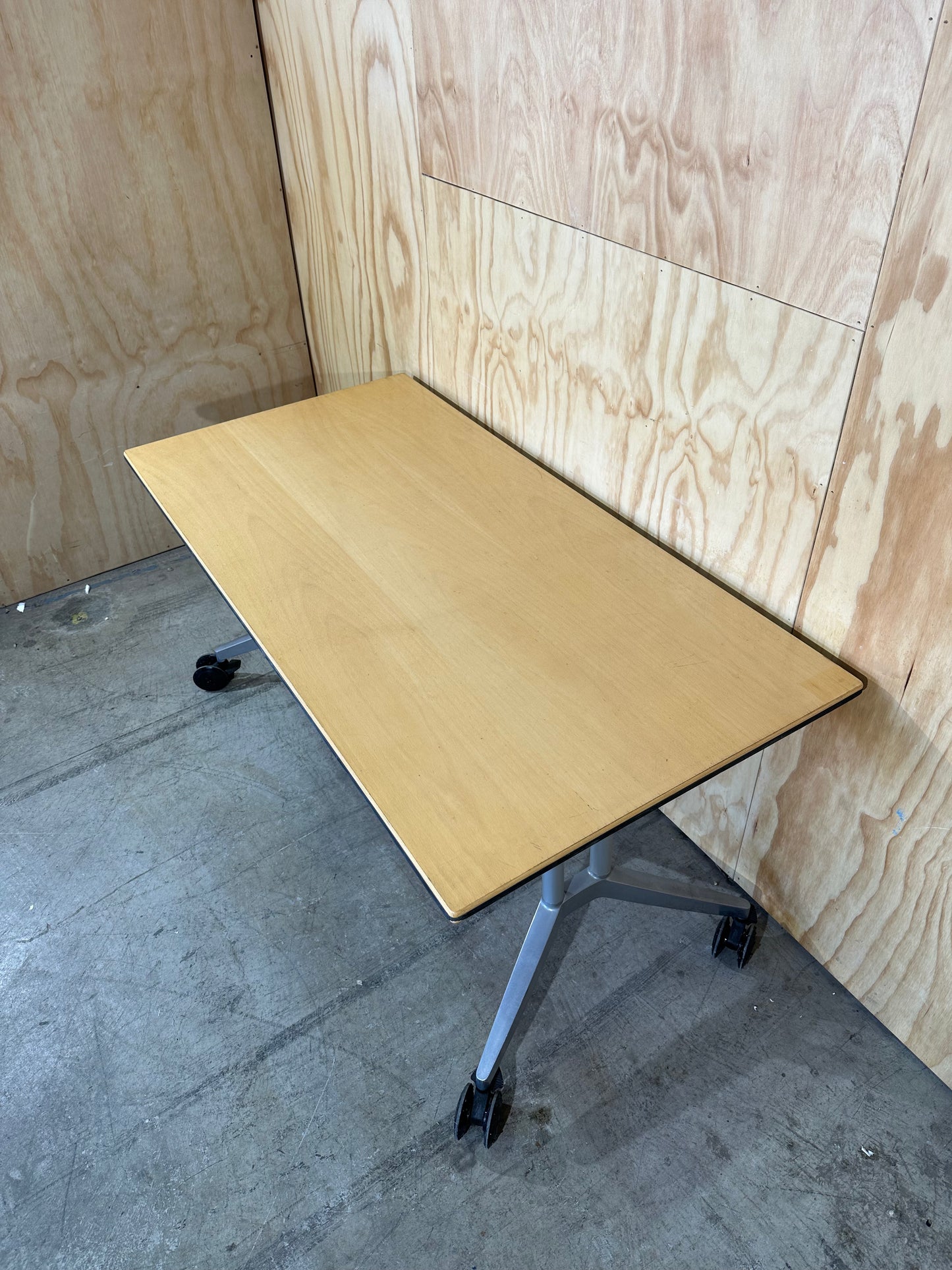 Wilkhahn table with light wood veneer on castors