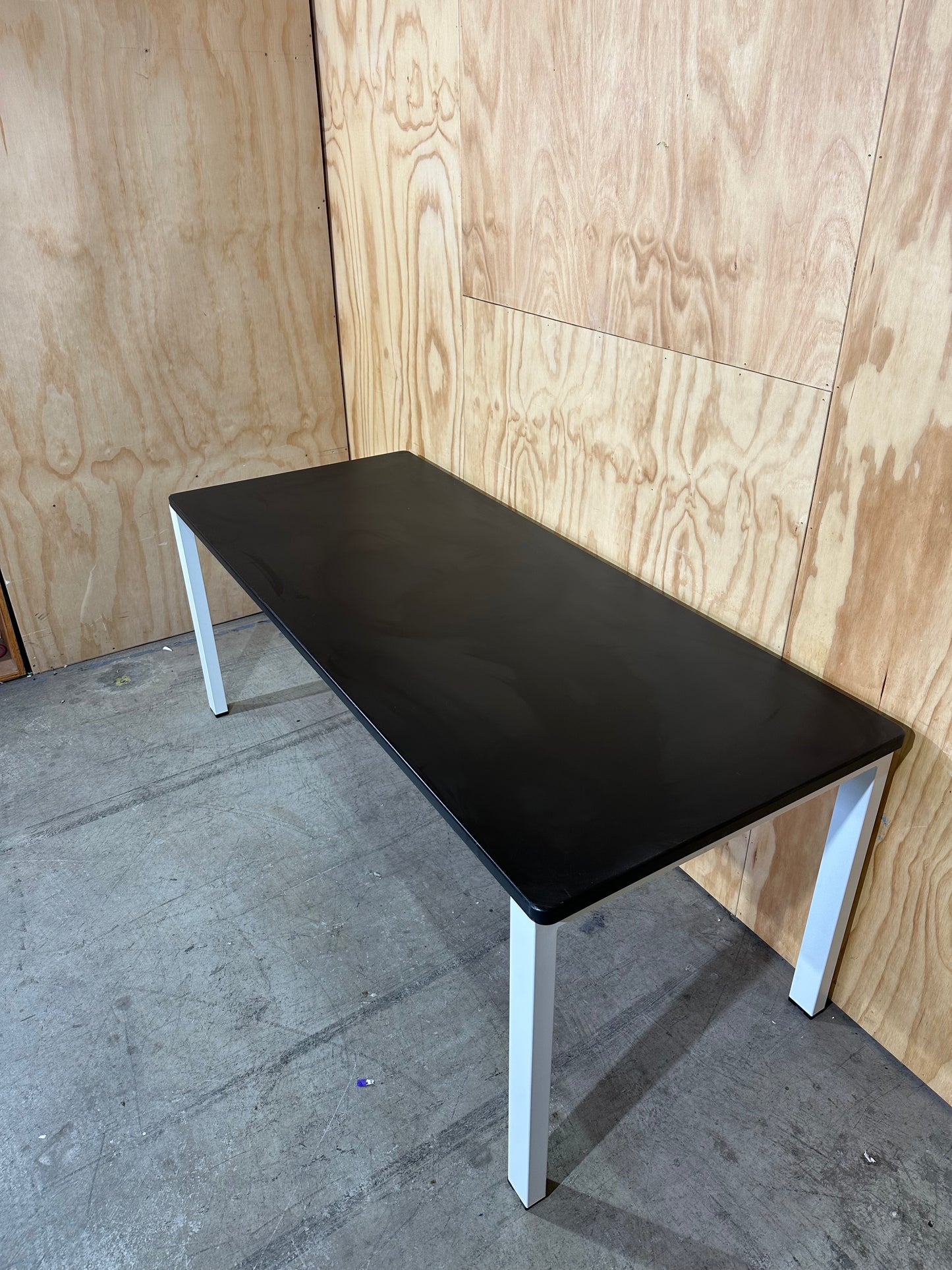 Long black desk on white frame