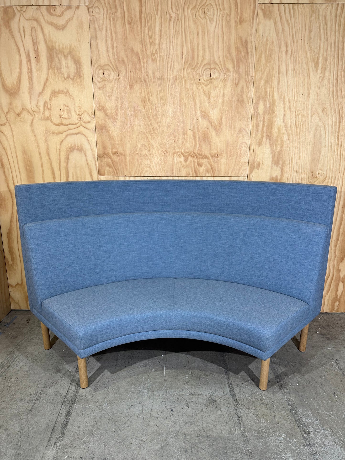 Curved blue highback sofa