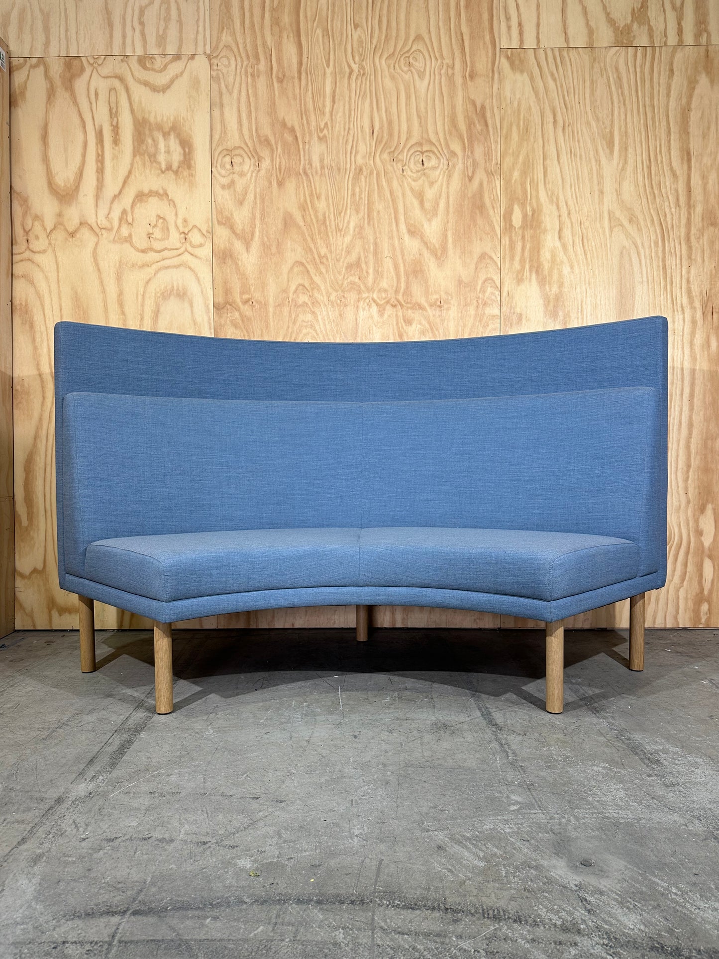 Curved blue highback sofa