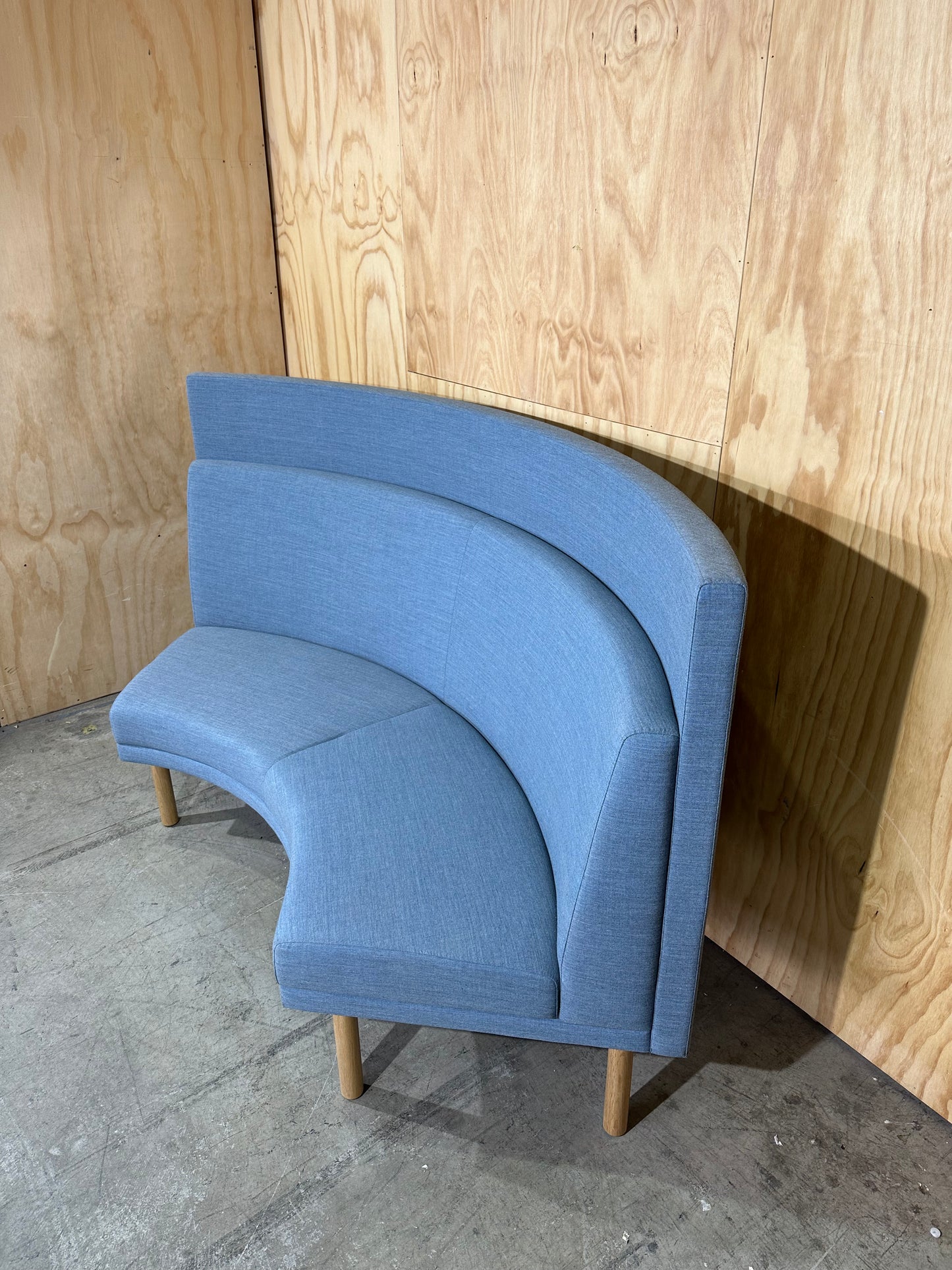 Curved blue highback sofa