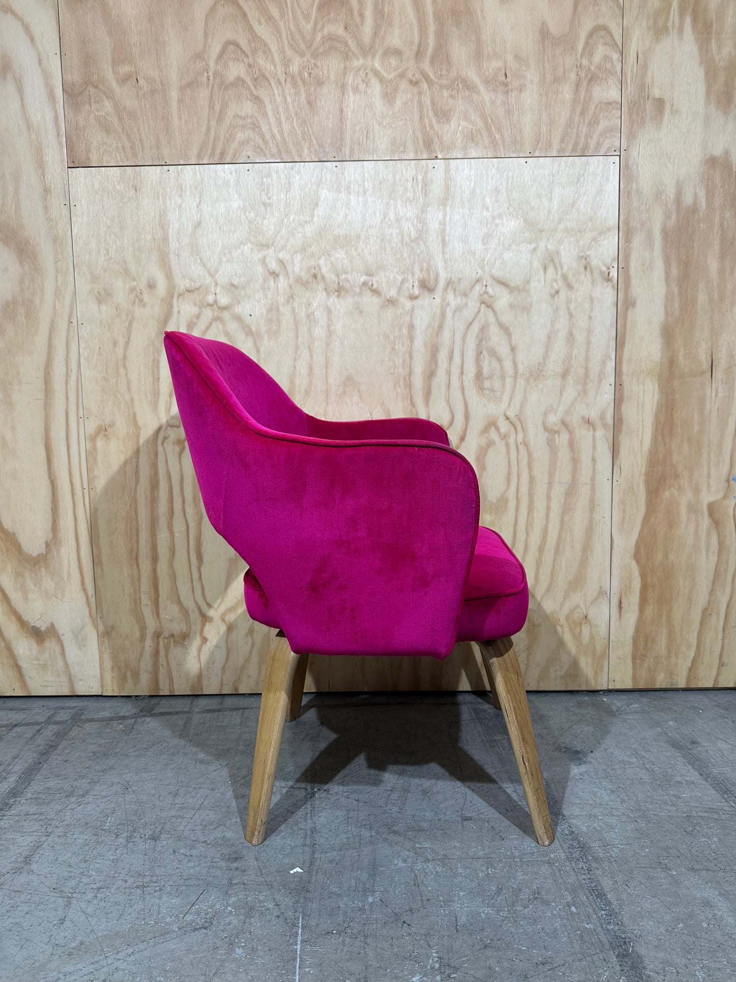 Hot pink velvet armchair on timber legs