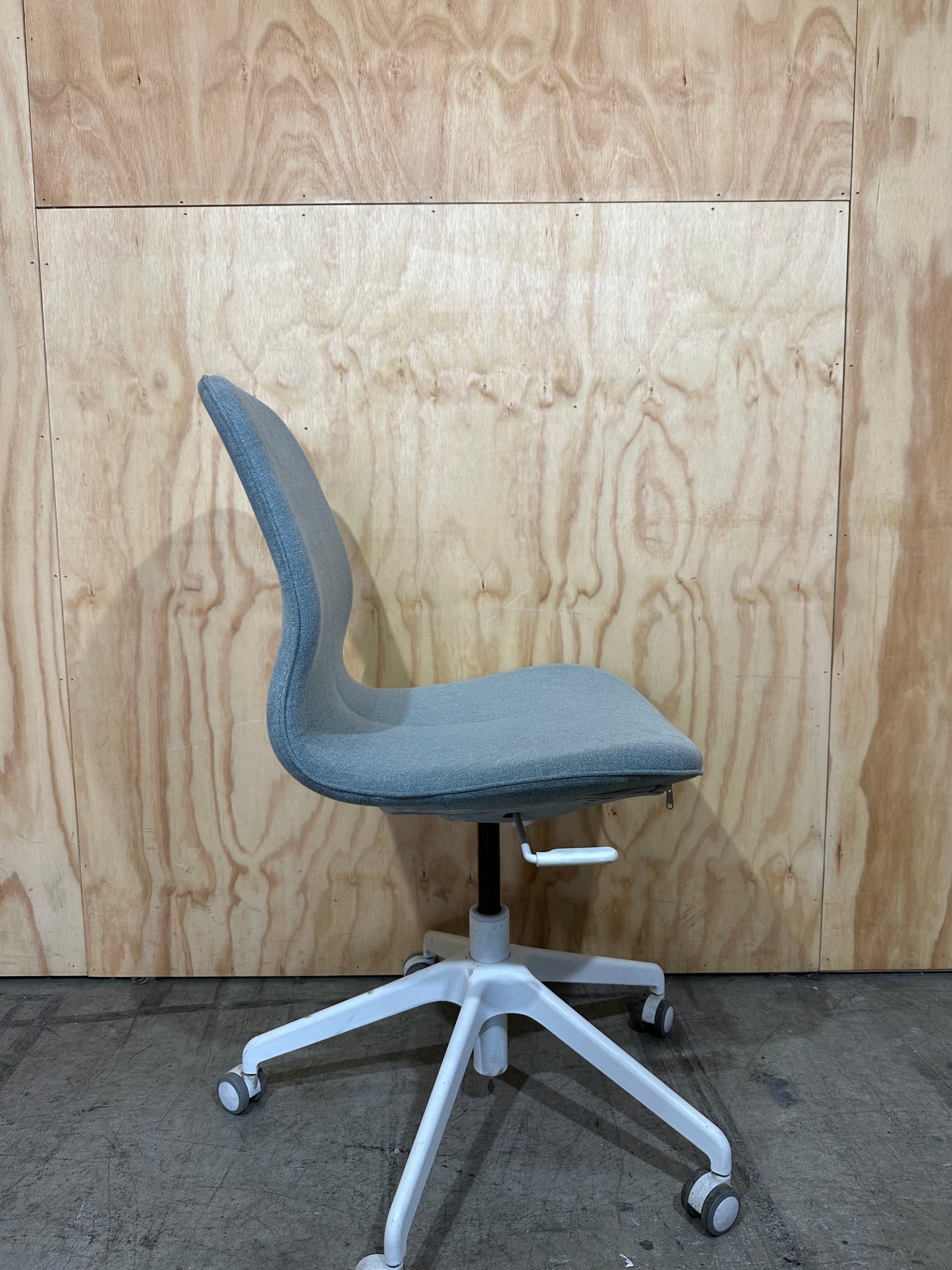Light blue office swivel chair on castors