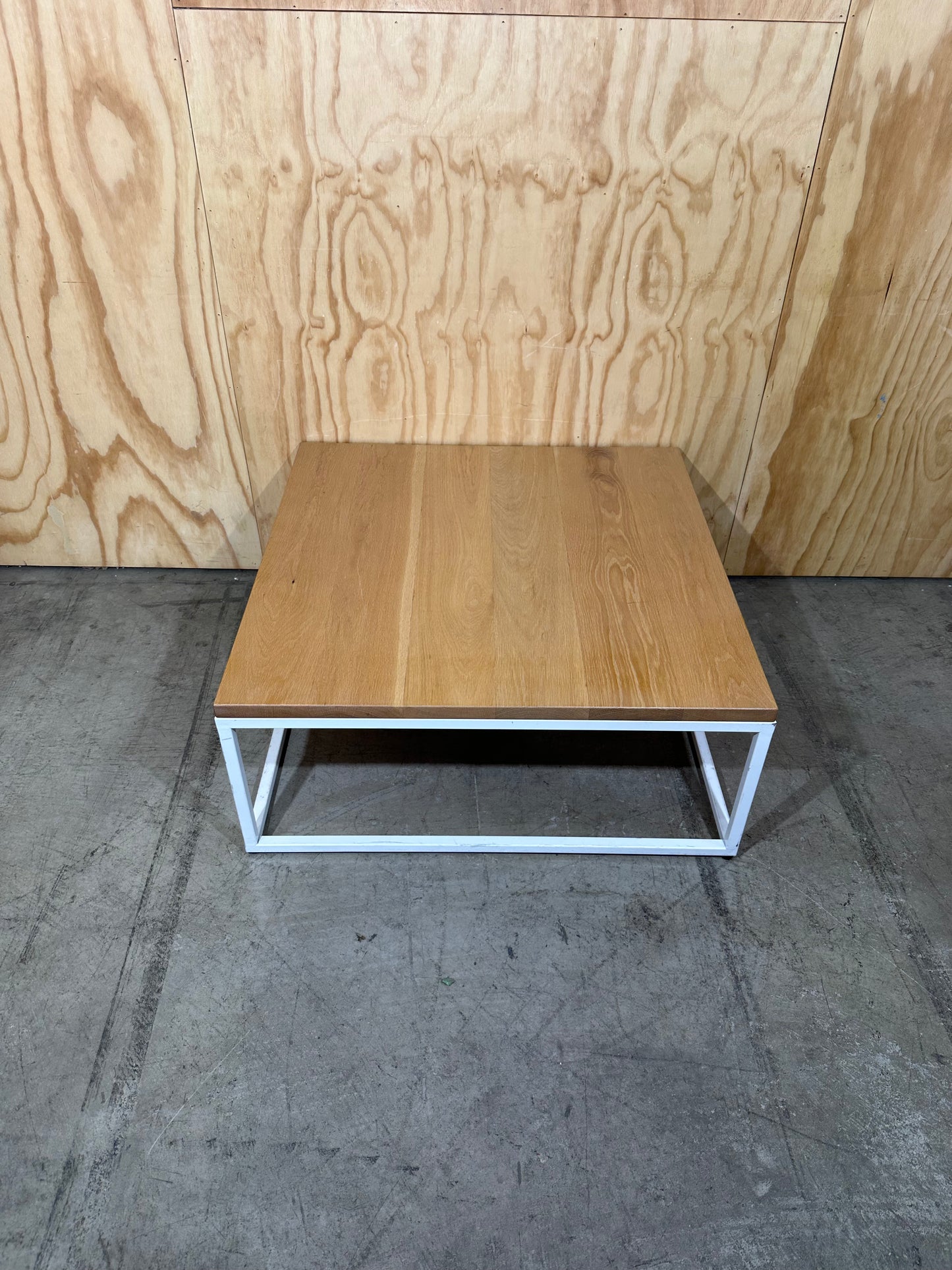 Square coffee table on white metal frame