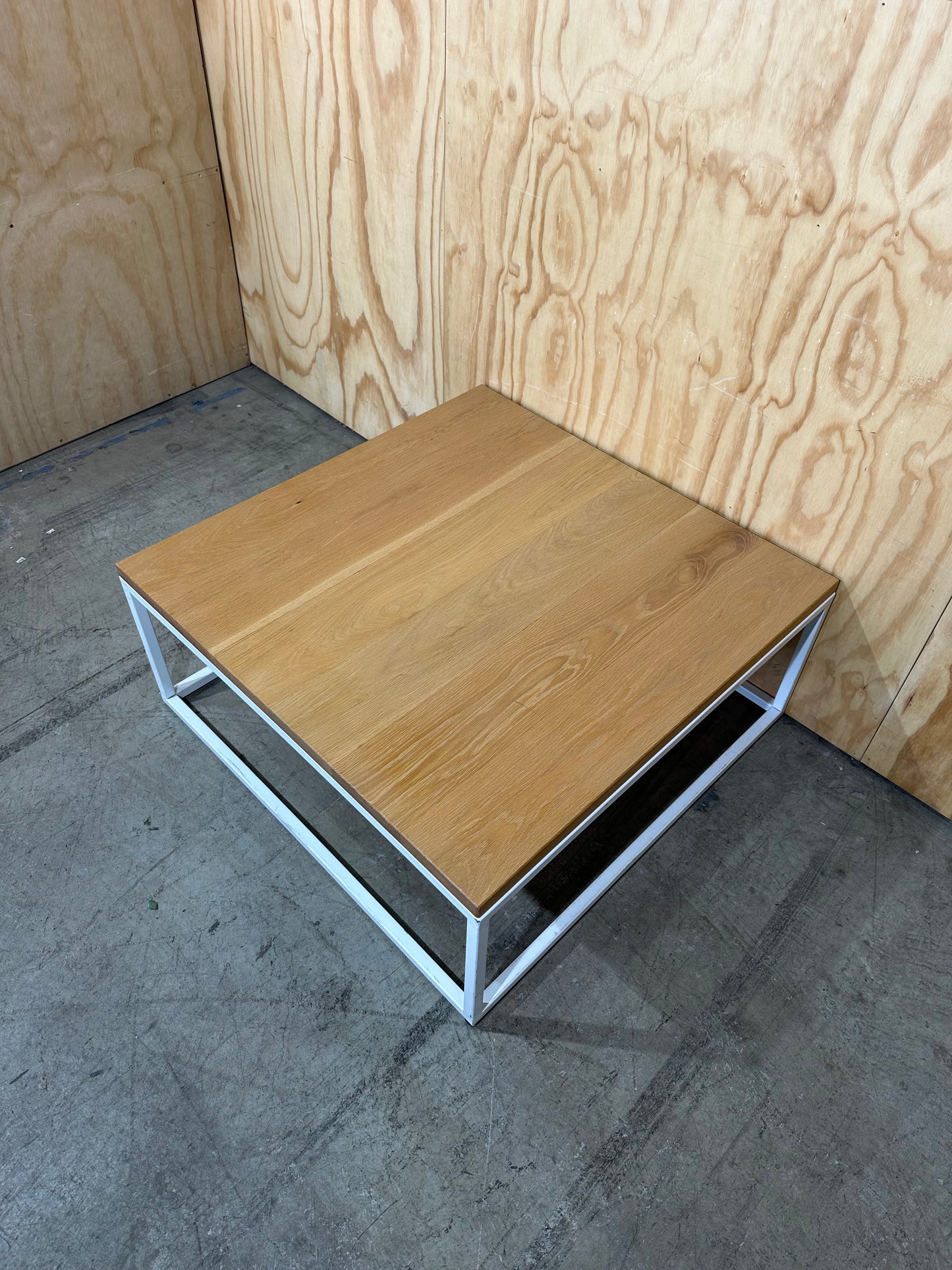 Square coffee table on white metal frame