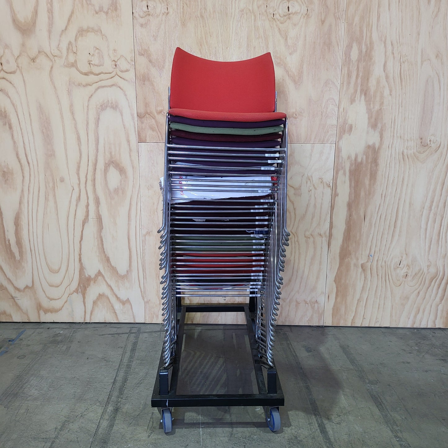 Stack of 26 Sled based visitor chairs with steel base on trolley