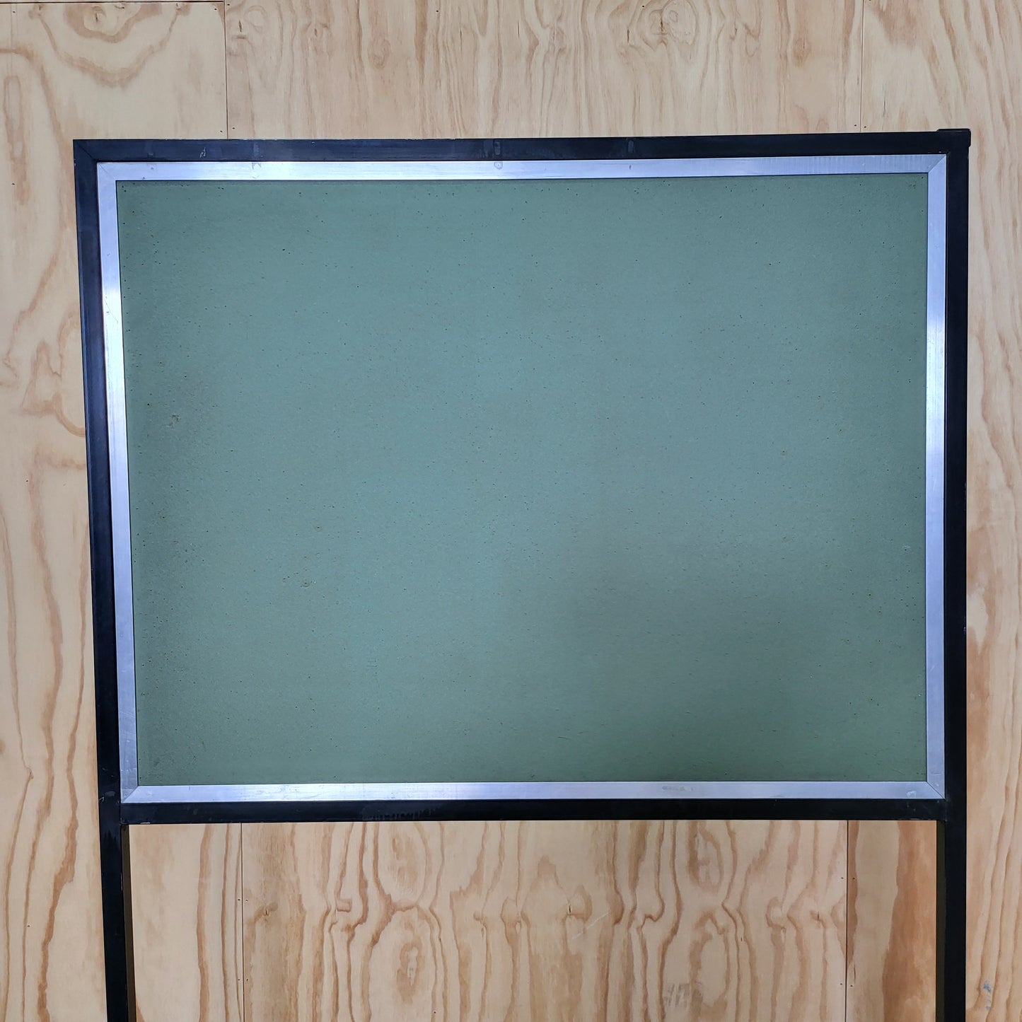Green notice board on wheels