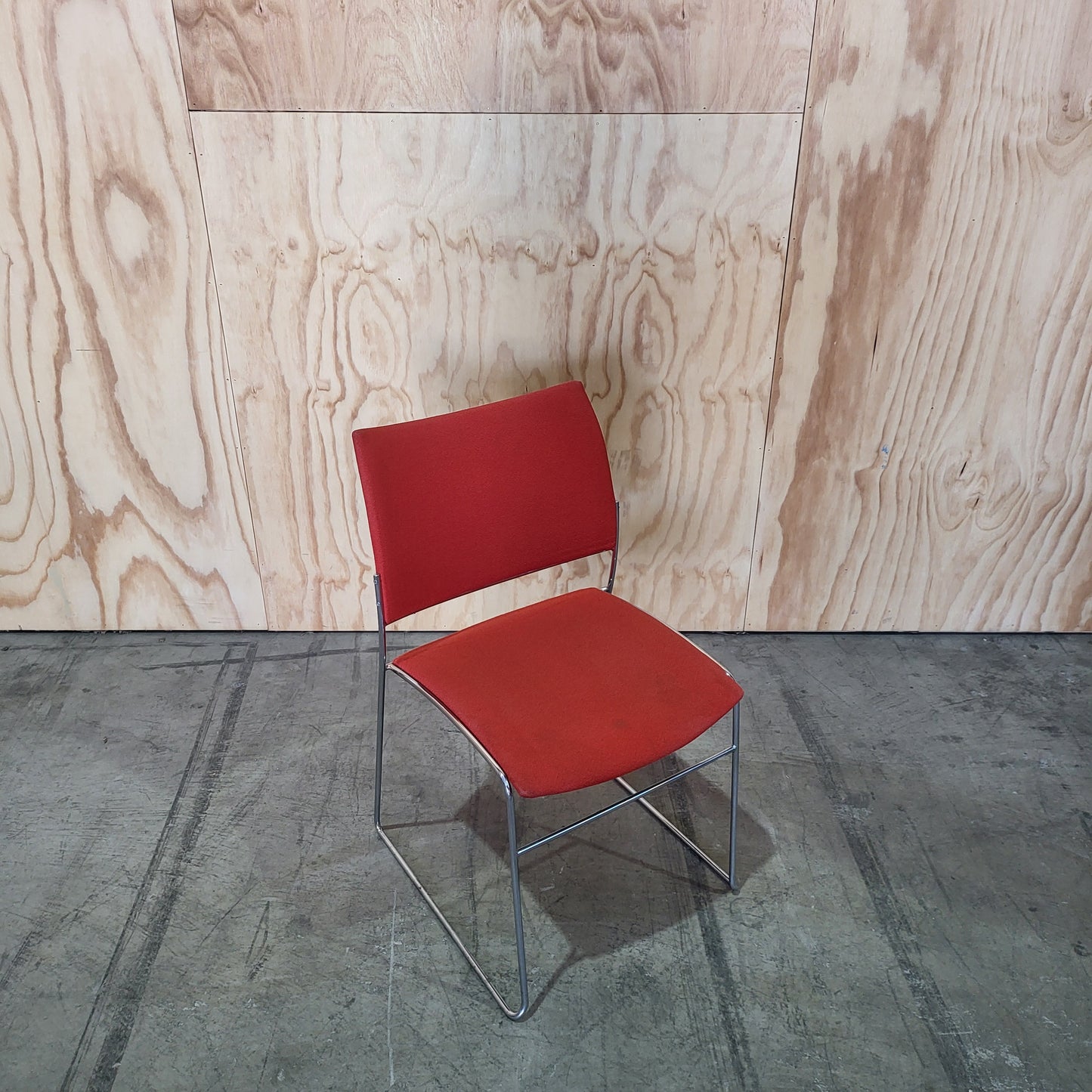 Stack of 26 Sled based visitor chairs with steel base on trolley
