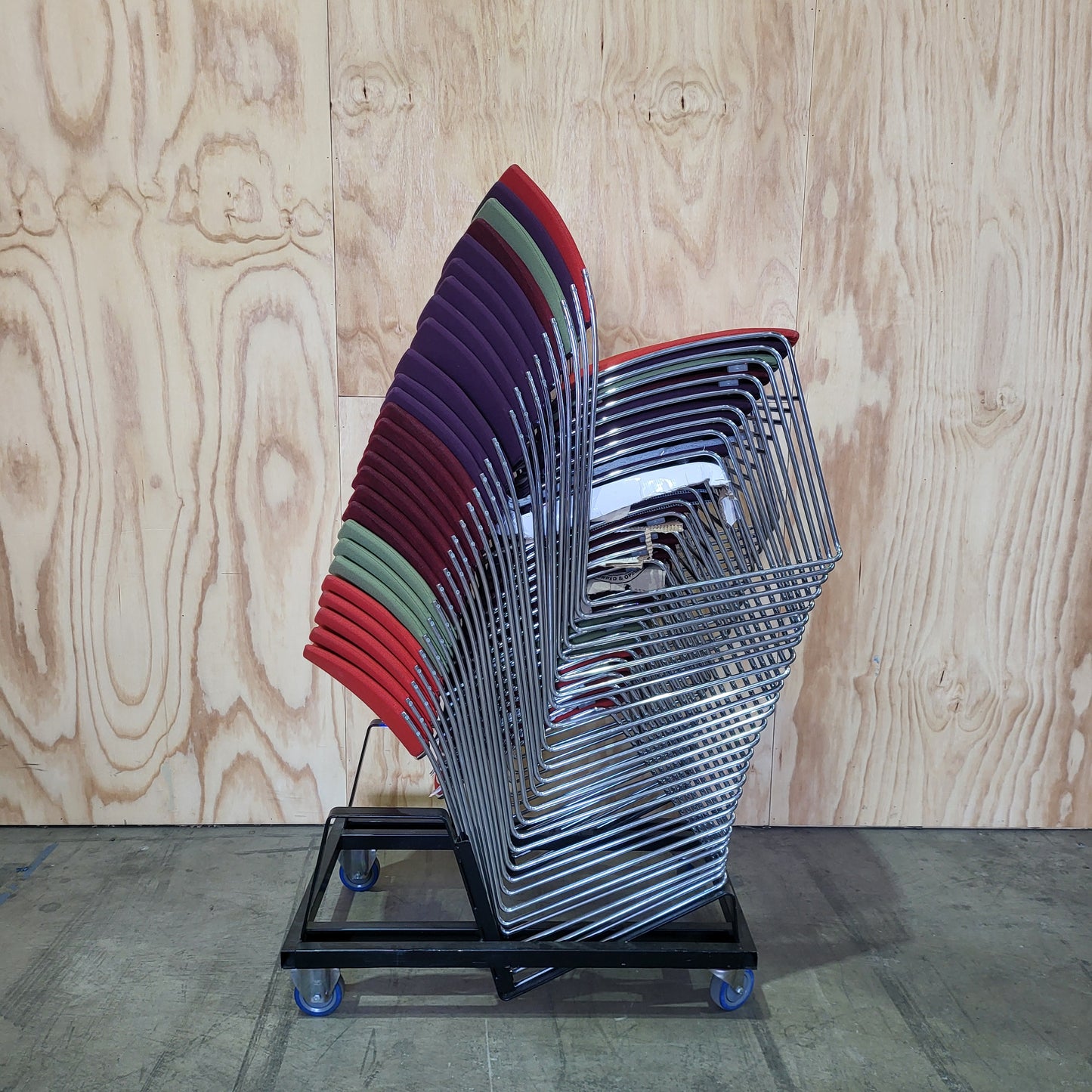 Stack of 26 Sled based visitor chairs with steel base on trolley