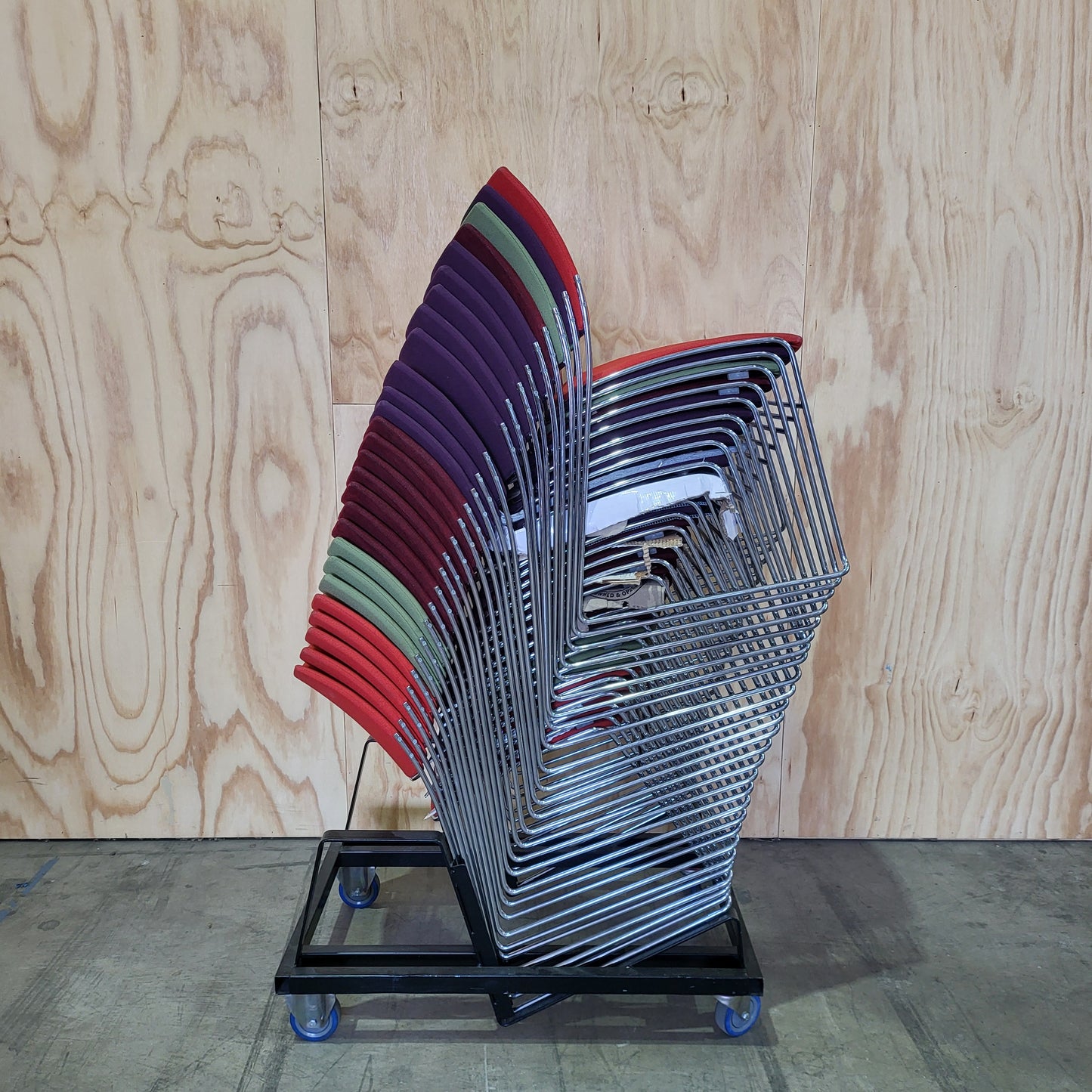 Stack of 26 Sled based visitor chairs with steel base on trolley