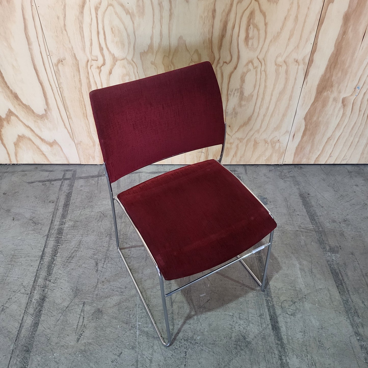 Stack of 26 Sled based visitor chairs with steel base on trolley