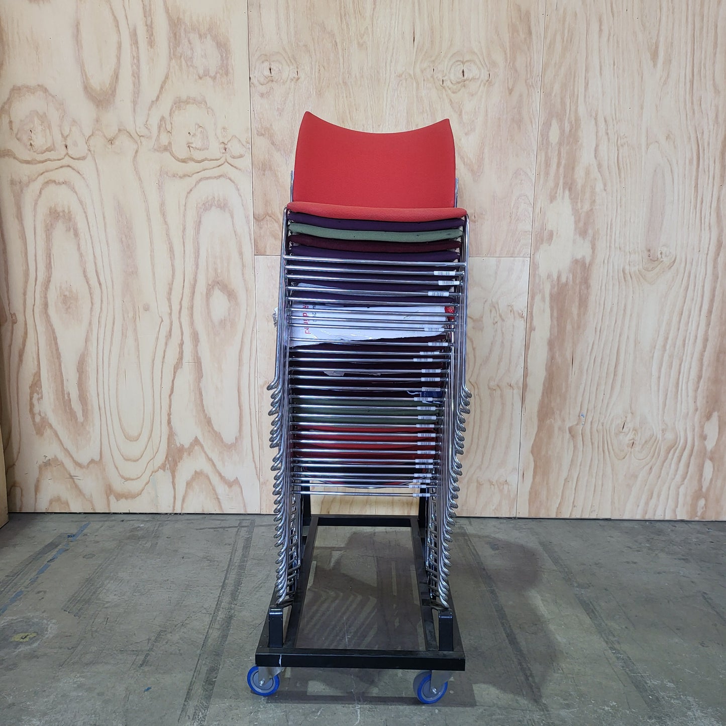 Stack of 26 Sled based visitor chairs with steel base on trolley
