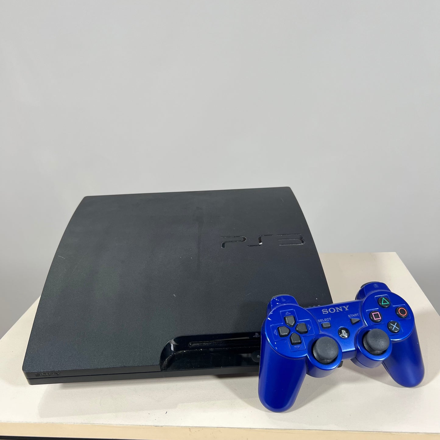 Sony PlayStation 3 Slim 300 GB with Official Sony DualShock 3 Blue Controller