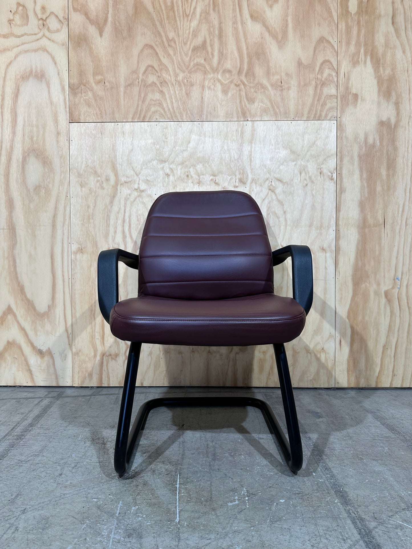 Maroon leather boardroom sled chair with arms