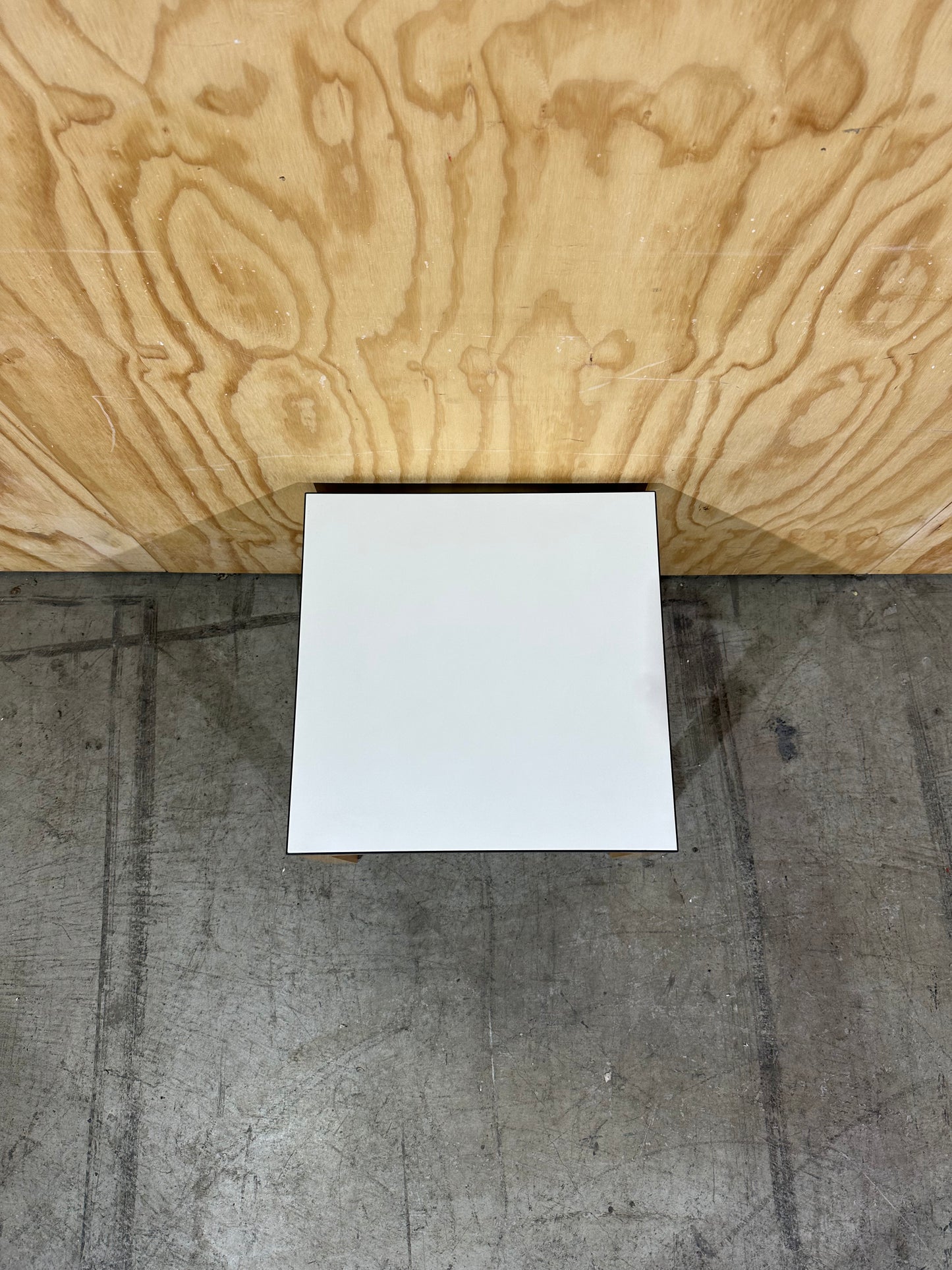 Square white top coffee table on brown legs