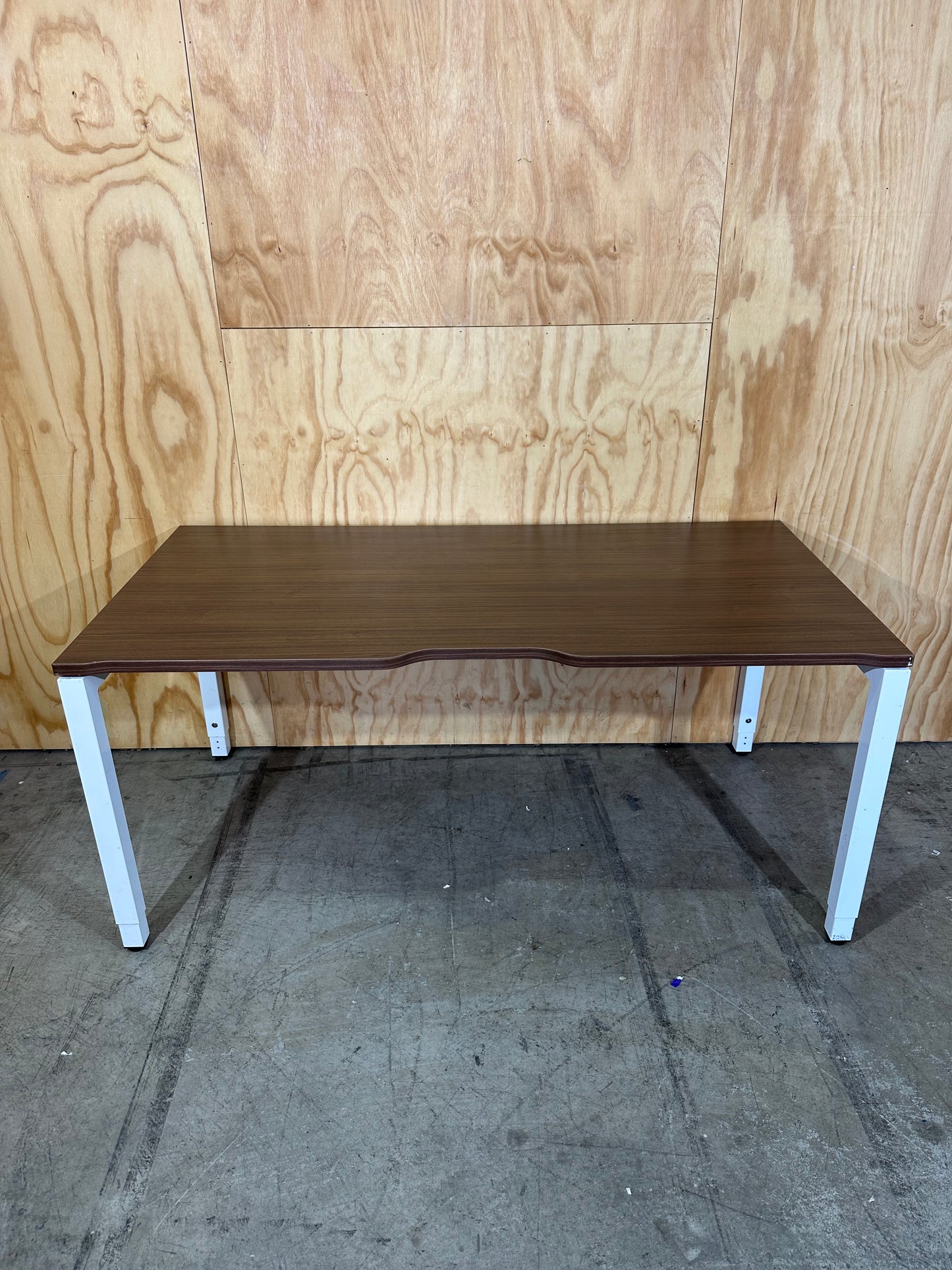 Dark wood veneer desk with white legs