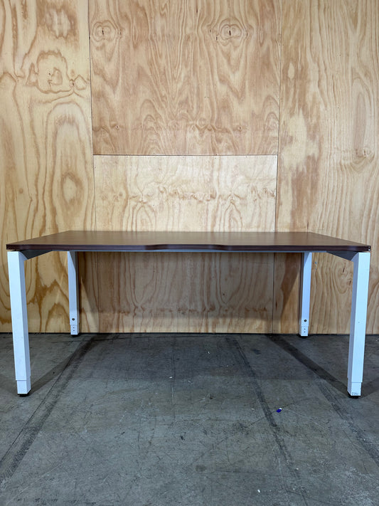 Dark wood veneer desk with white legs