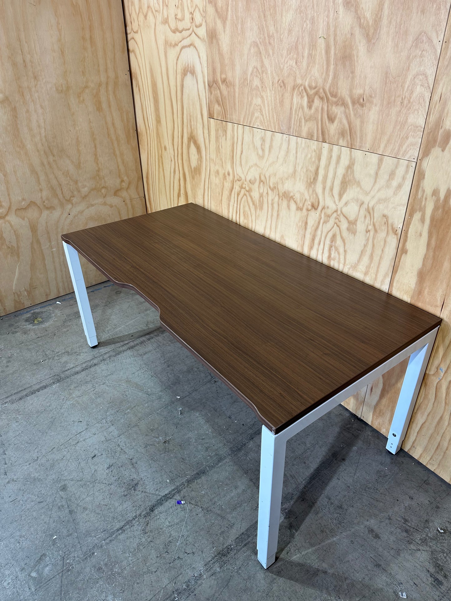 Dark wood veneer desk with white legs