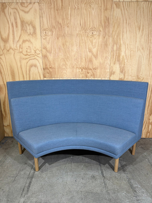 Curved blue highback sofa