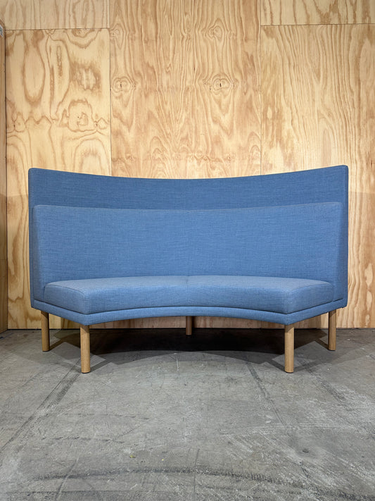 Curved blue highback sofa